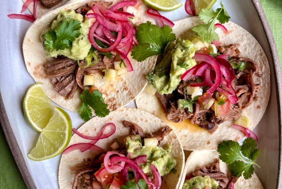 Hereford beef brisket tacos with charred pineapple salsa and pink pickled onions