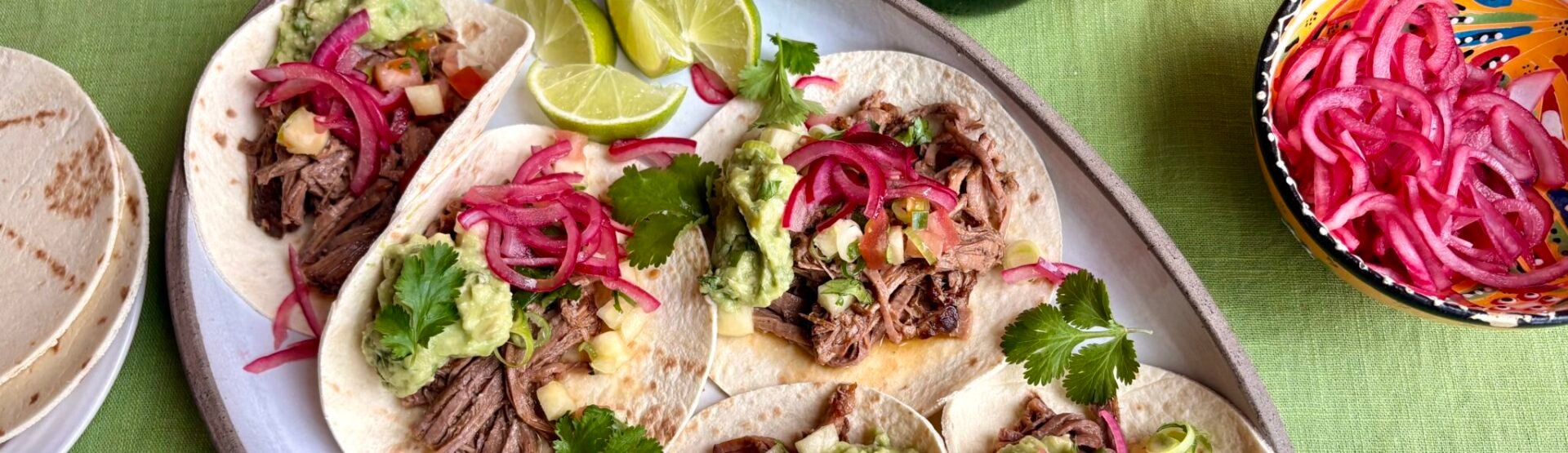 Hereford beef brisket tacos with charred pineapple salsa and pink pickled onions